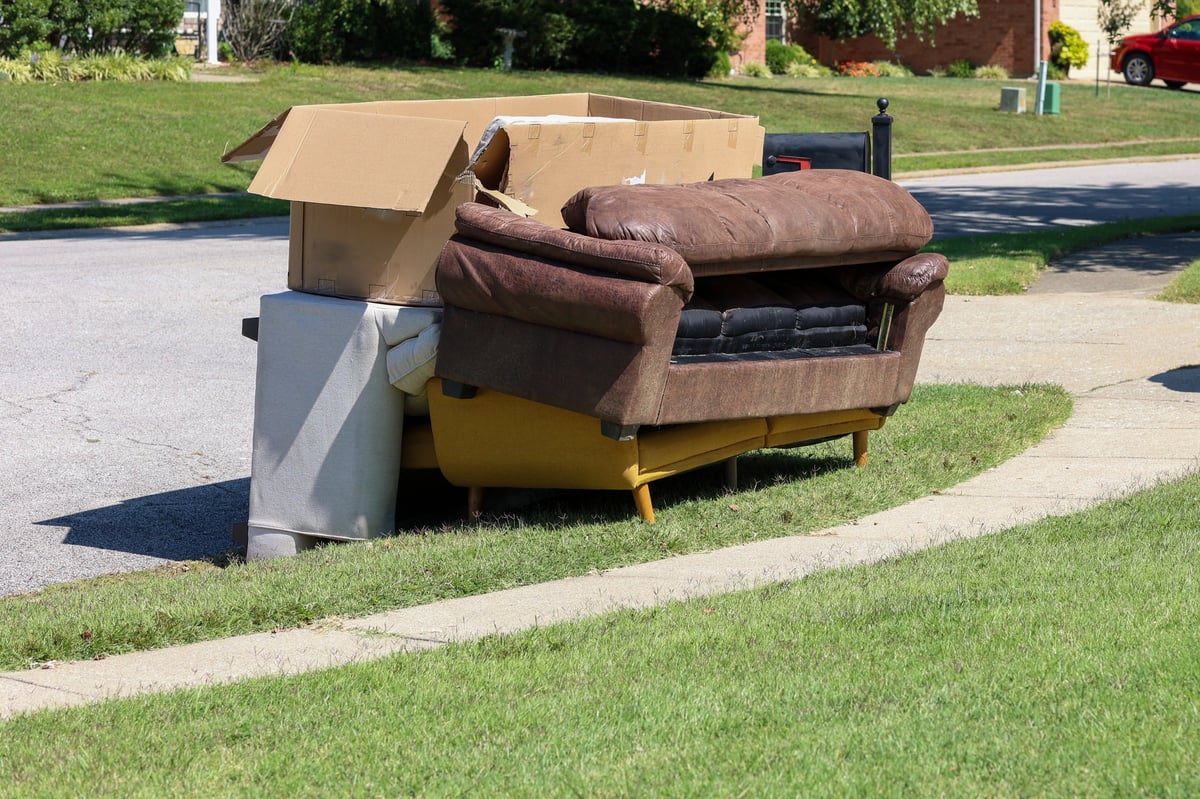 Disposing of old furniture on a sidewalk
